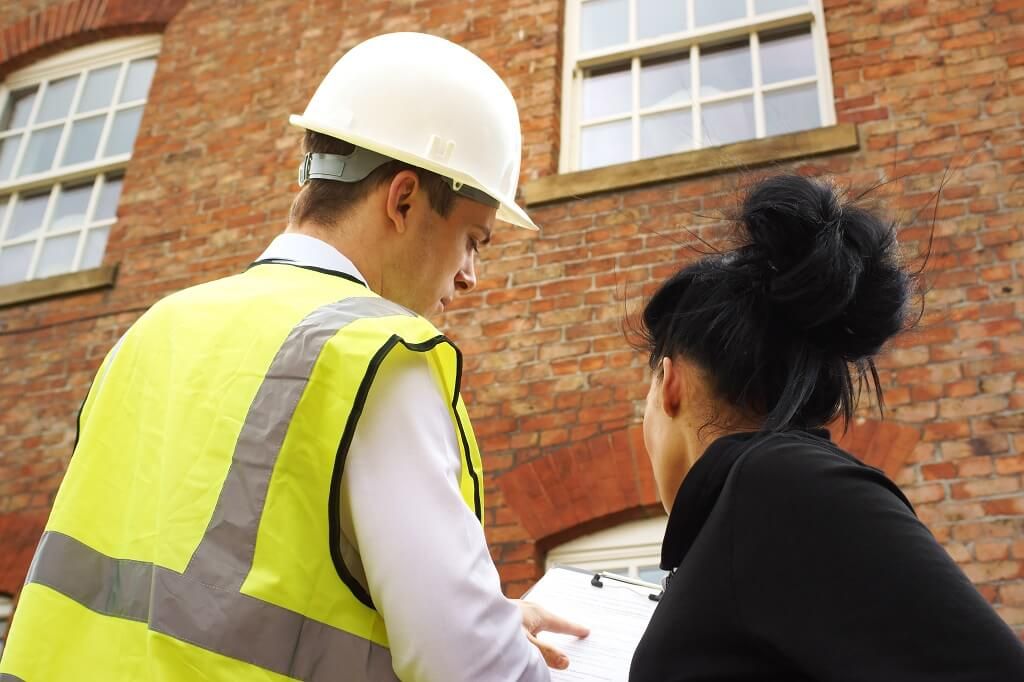 Builder showing plans to a home owner