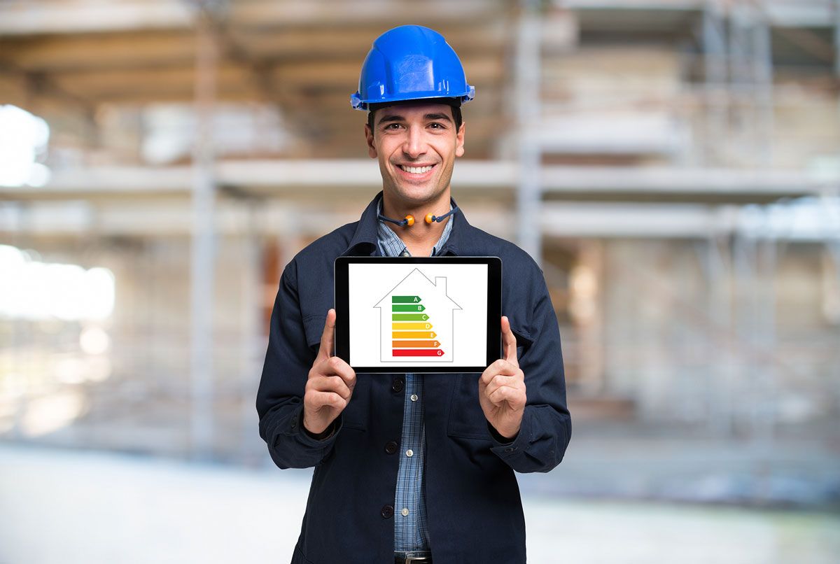 A builder holding a tablet with a energy rate guide